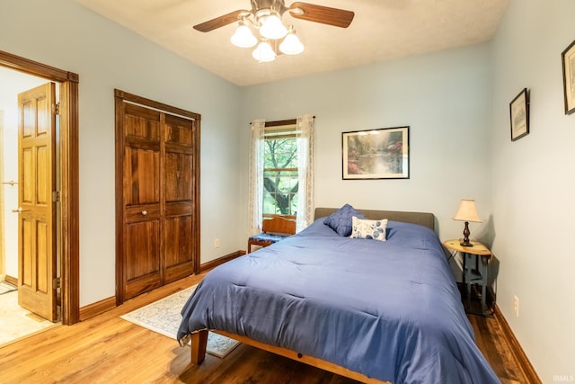 5003 N Chatham Dr, Bloomington, IN 47404 - bedroom with light wood-style floors, baseboards, a closet, and a ceiling fan