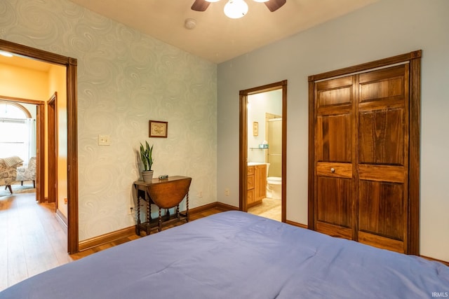 5003 N Chatham Dr, Bloomington, IN 47404 - bedroom featuring light wood-style flooring, baseboards, connected bathroom, and ceiling fan