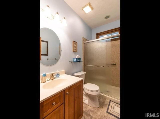 5003 N Chatham Dr, Bloomington, IN 47404 - bathroom featuring toilet, vanity, a stall shower, and tile patterned flooring