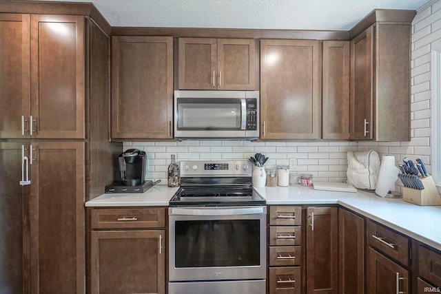 60 Elder Ct, Lafayette, IN 47905 - kitchen with appliances with stainless steel finishes, tasteful backsplash, and light countertops