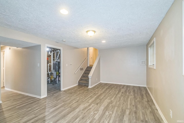 11114 E Wismar Dr, Indianapolis, IN 46235 - finished basement featuring light wood-style floors, a textured ceiling, stairs, and baseboards