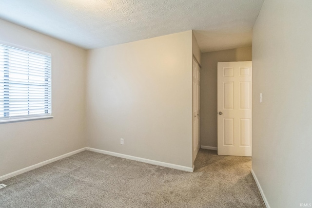 11114 E Wismar Dr, Indianapolis, IN 46235 - spare room featuring light colored carpet, baseboards, and a textured ceiling