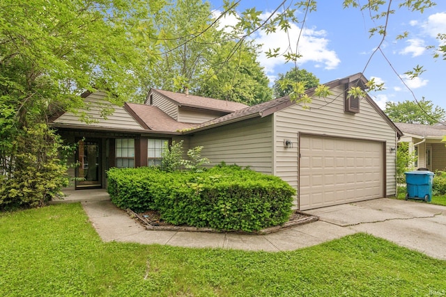 11114 E Wismar Dr, Indianapolis, IN 46235 - view of front facade featuring a garage, asphalt driveway, a front yard, and a shingled roof
