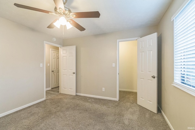 11114 E Wismar Dr, Indianapolis, IN 46235 - unfurnished bedroom featuring light carpet, baseboards, and a ceiling fan