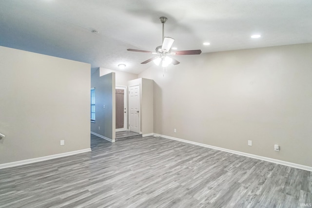 11114 E Wismar Dr, Indianapolis, IN 46235 - empty room featuring a ceiling fan, wood finished floors, baseboards, recessed lighting, and lofted ceiling