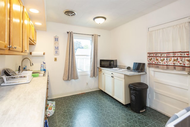 2806 Milburn Blvd, Mishawaka, IN 46544 - kitchen featuring dark flooring, light countertops, and a sink