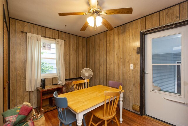 2806 Milburn Blvd, Mishawaka, IN 46544 - dining room with wood finished floors, wood walls, and a ceiling fan