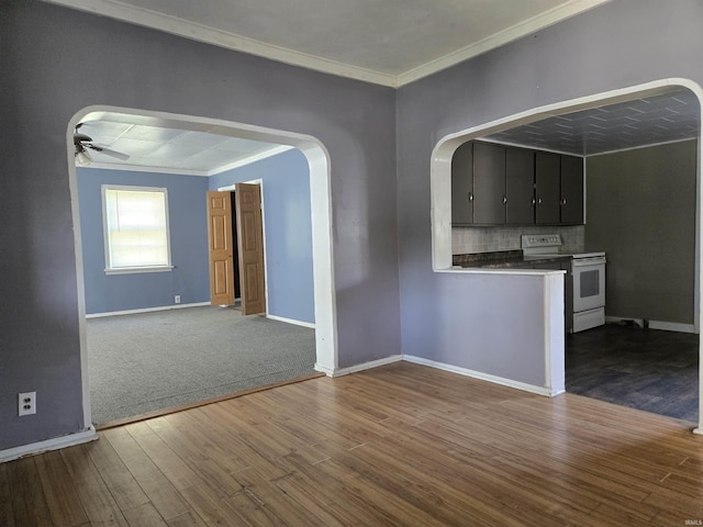 150 W Lake St, Laketon, IN 46943 - unfurnished living room featuring ornamental molding, a ceiling fan, wood finished floors, arched walkways, and baseboards