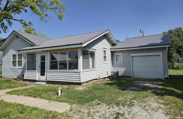 150 W Lake St, Laketon, IN 46943 - single story home with metal roof, a front lawn, a sunroom, central AC, and driveway
