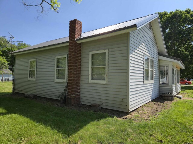150 W Lake St, Laketon, IN 46943 - view of home's exterior featuring a chimney and metal roof