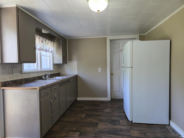 150 W Lake St, Laketon, IN 46943 - kitchen featuring freestanding refrigerator, a sink, dark countertops, dark wood finished floors, and backsplash