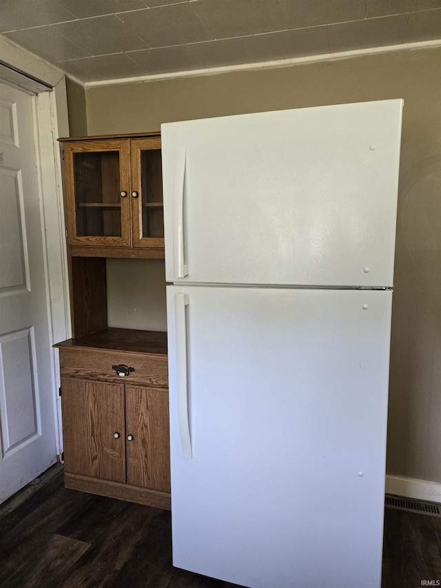 150 W Lake St, Laketon, IN 46943 - detailed view of freestanding refrigerator, brown cabinets, dark wood finished floors, and dark countertops