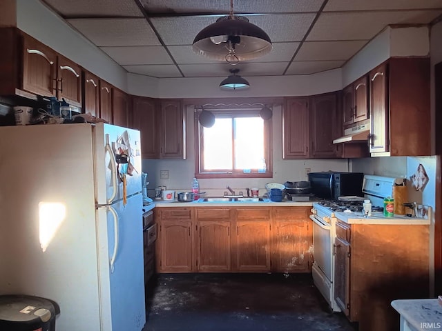 804 W 1st St, Albany, IN 47320 - kitchen featuring white appliances, under cabinet range hood, concrete floors, light countertops, and a paneled ceiling