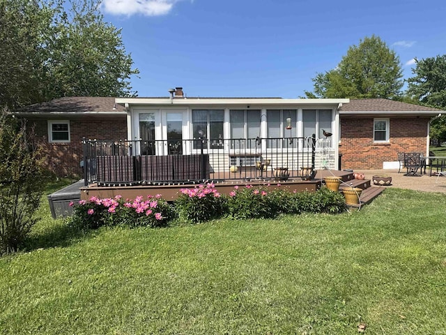8133 Maple Ln, Newburgh, IN 47630 - rear view of house with brick siding, a sunroom, and a lawn