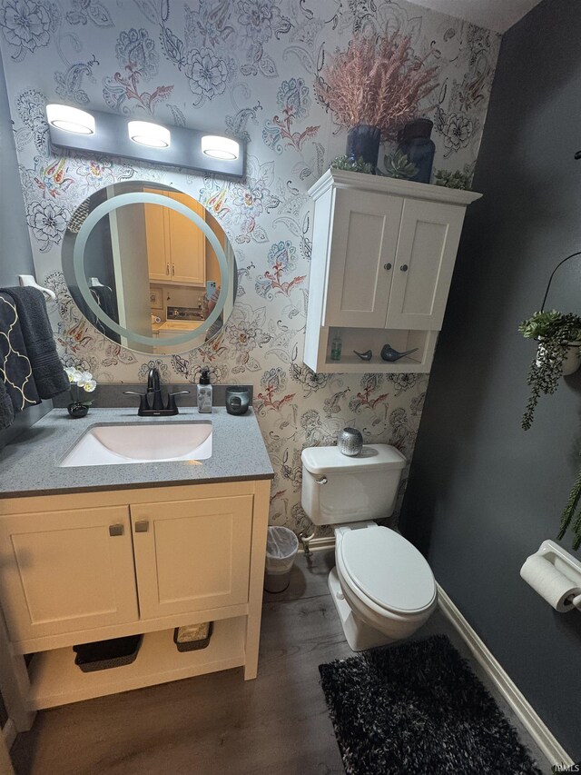 8133 Maple Ln, Newburgh, IN 47630 - bathroom with wallpapered walls, wood finished floors, vanity, and toilet
