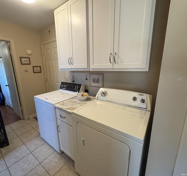 8133 Maple Ln, Newburgh, IN 47630 - laundry area with cabinet space, light tile patterned floors, and separate washer and dryer