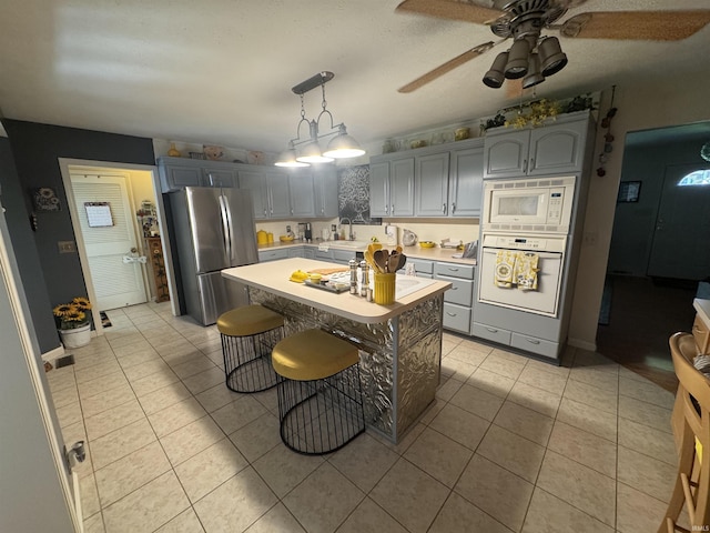 8133 Maple Ln, Newburgh, IN 47630 - kitchen with white appliances, a sink, light countertops, light tile patterned flooring, and gray cabinetry