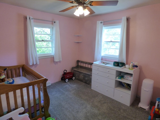 1612 N Wellington St, South Bend, IN 46628 - bedroom featuring multiple windows, a crib, carpet floors, and a ceiling fan