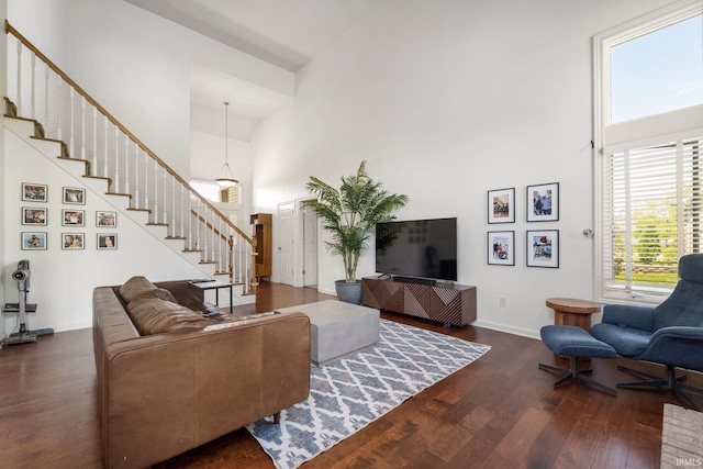 1933 Millennium Xing, Fort Wayne, IN 46845 - living area featuring a towering ceiling, stairs, dark wood-style floors, and baseboards