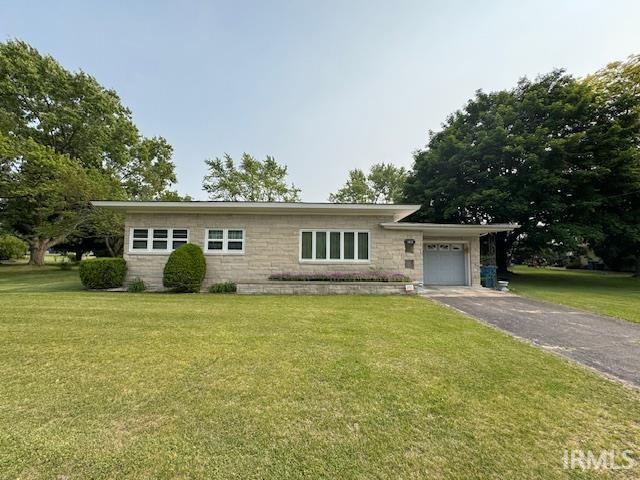 1402 E Culver Rd, Knox, IN 46534 - view of front facade with a garage, driveway, stone siding, and a front lawn