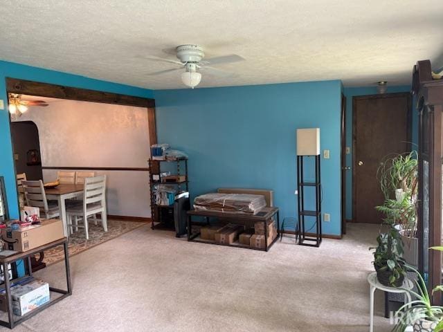 1402 E Culver Rd, Knox, IN 46534 - carpeted living area featuring ceiling fan, arched walkways, and baseboards