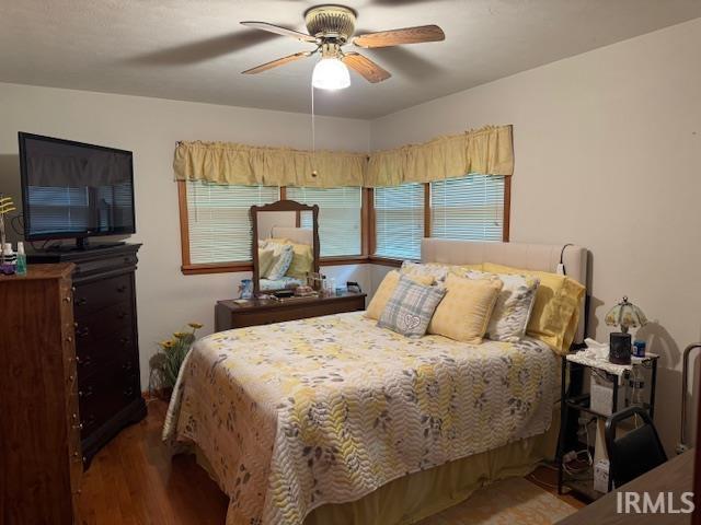 1402 E Culver Rd, Knox, IN 46534 - bedroom featuring wood finished floors, multiple windows, and ceiling fan