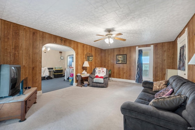 405 Miner Rd, Avilla, IN 46710 - living area with arched walkways, wooden walls, carpet floors, and ceiling fan