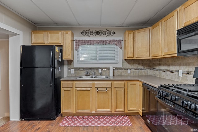 1804 Maple St, Lafayette, IN 47904 - kitchen with black appliances, a sink, light brown cabinets, wood finished floors, and a drop ceiling