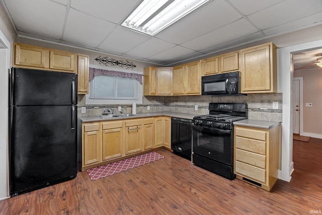 1804 Maple St, Lafayette, IN 47904 - kitchen with black appliances, light brown cabinets, a sink, dark wood finished floors, and a paneled ceiling