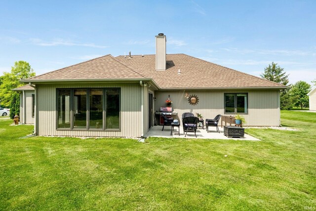 6811 Bittersweet Dells Ct, Fort Wayne, IN 46814 - back of property with a patio area, a chimney, a lawn, roof with shingles, and a fire pit
