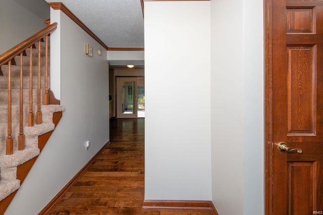 4431 Mccomb Rd, Huntertown, IN 46748 - hall featuring stairway, ornamental molding, dark wood-style flooring, a textured ceiling, and baseboards