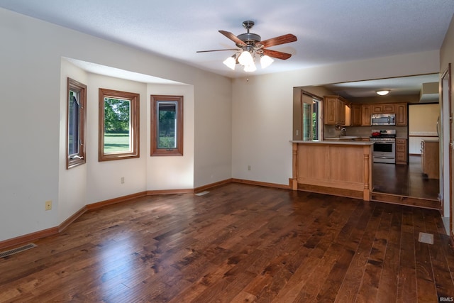 4431 Mccomb Rd, Huntertown, IN 46748 - unfurnished living room with dark wood-style flooring, ceiling fan, baseboards, and a sink