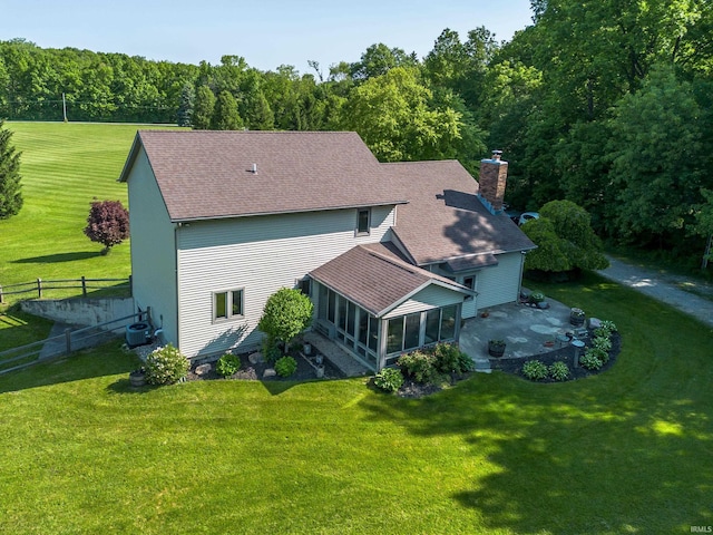 4431 Mccomb Rd, Huntertown, IN 46748 - rear view of property with a sunroom, a chimney, a shingled roof, central AC unit, and a patio
