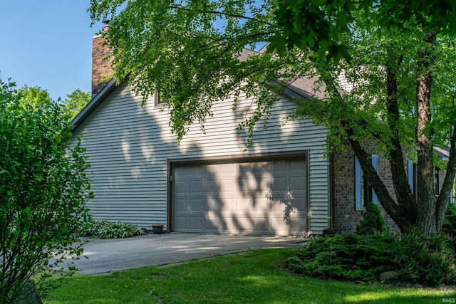 4431 Mccomb Rd, Huntertown, IN 46748 - view of home's exterior with driveway, a garage, and a chimney