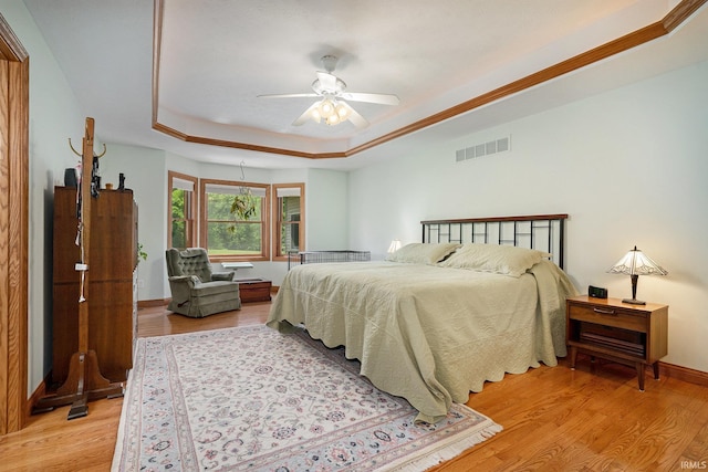 2617 W Union St, Claypool, IN 46510 - bedroom featuring light wood finished floors, a raised ceiling, baseboards, and a ceiling fan