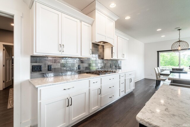 119 Artisan Pass, Fort Wayne, IN 46845 - kitchen with stainless steel gas stovetop, a sink, dark wood-style floors, baseboards, and white cabinetry