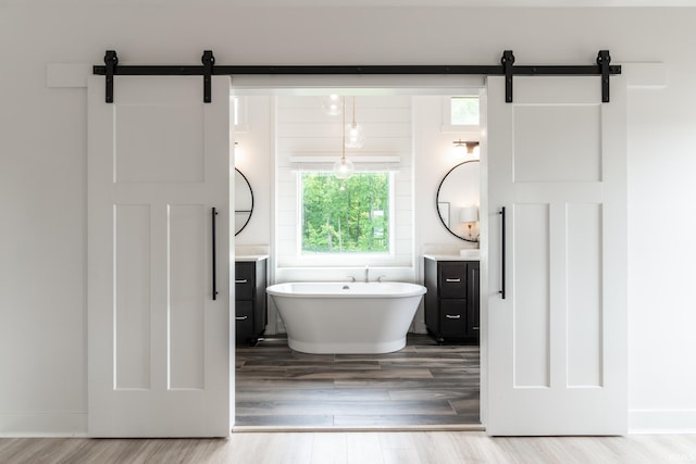 119 Artisan Pass, Fort Wayne, IN 46845 - bathroom with vanity, wood finished floors, a freestanding tub, and baseboards