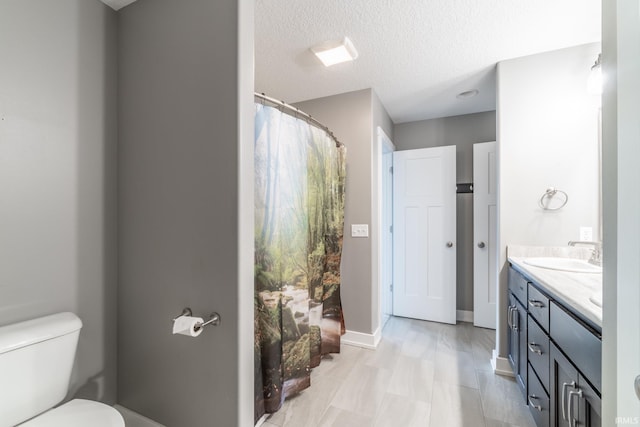 119 Artisan Pass, Fort Wayne, IN 46845 - bathroom featuring double vanity, toilet, a textured ceiling, and baseboards