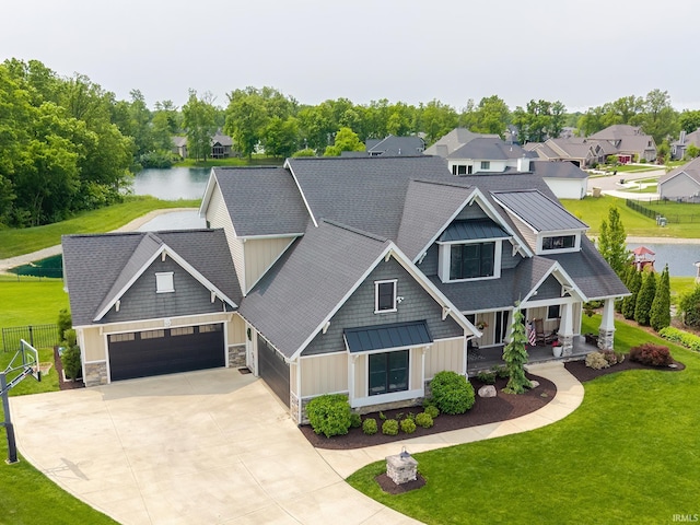 119 Artisan Pass, Fort Wayne, IN 46845 - craftsman house with a standing seam roof, covered porch, driveway, a water view, and an attached garage