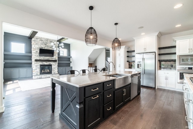 119 Artisan Pass, Fort Wayne, IN 46845 - kitchen with open shelves, stainless steel appliances, a sink, white cabinetry, and a kitchen breakfast bar