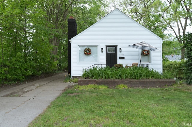 1409 Miner St, South Bend, IN 46617 - view of front facade featuring a chimney and a front yard