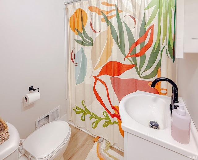 1409 Miner St, South Bend, IN 46617 - full bath featuring toilet, wood finished floors, and vanity