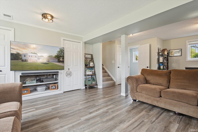 12678 Pat Ln, Granger, IN 46530 - living area with stairway, wood finished floors, a textured ceiling, and baseboards