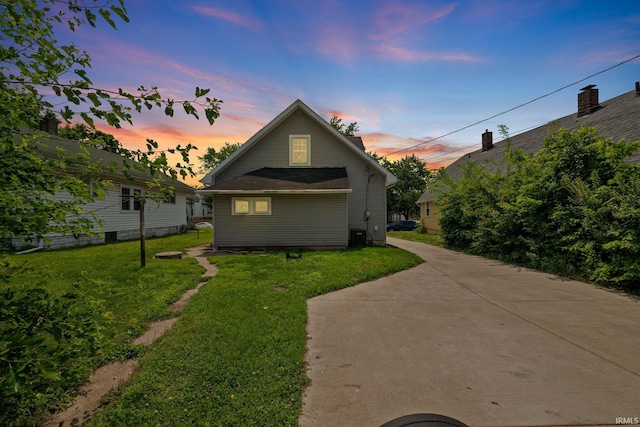 1706 Pierce St, Lafayette, IN 47905 - back of house at dusk featuring a lawn