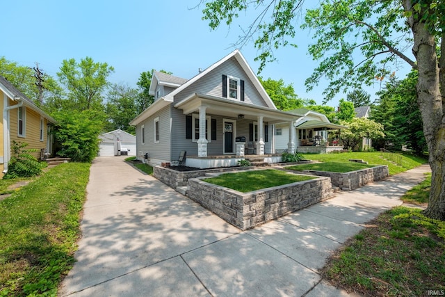 1706 Pierce St, Lafayette, IN 47905 - view of front of house with a porch, an outbuilding, a detached garage, and a front lawn
