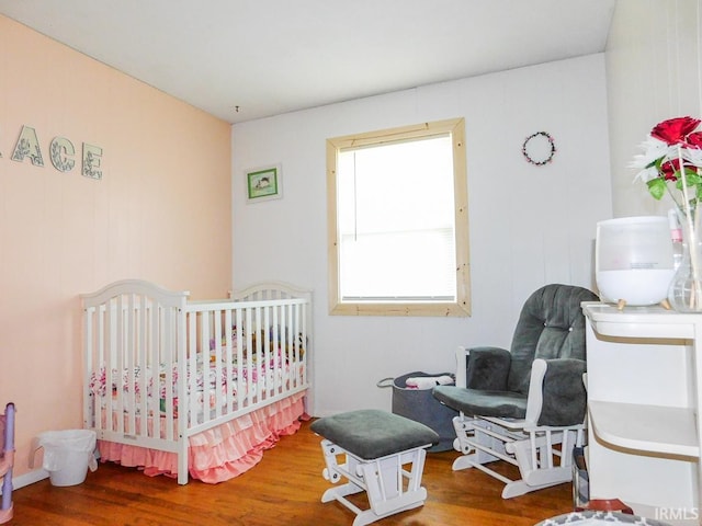 2363 N Oak Dr, Bluffton, IN 46714 - bedroom with wood finished floors and a crib