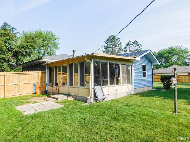 2363 N Oak Dr, Bluffton, IN 46714 - back of property featuring a sunroom and a fenced backyard