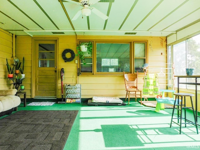 2363 N Oak Dr, Bluffton, IN 46714 - sunroom featuring wooden walls, a ceiling fan, and carpet flooring