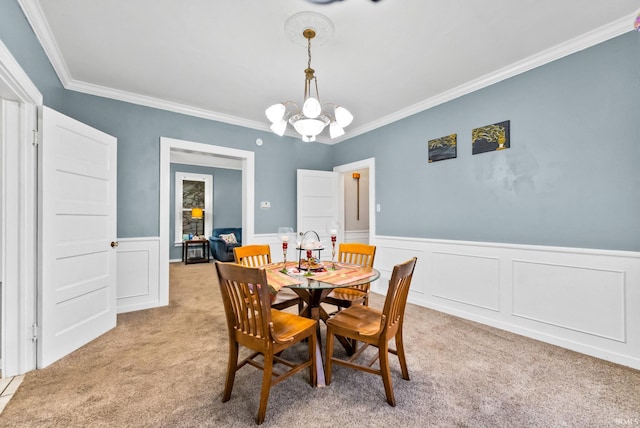 708 E Center St, Warsaw, IN 46580 - dining area with light colored carpet, ornamental molding, a chandelier, and a wainscoted wall
