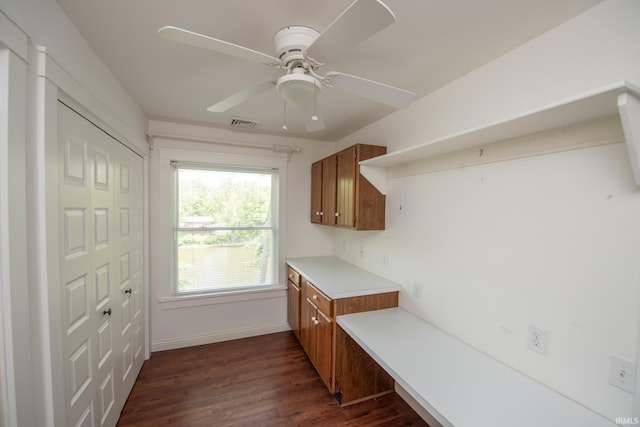 12071 W Tecumseh Bend Rd, Brookston, IN 47923 - kitchen featuring brown cabinetry, dark wood-style flooring, light countertops, and ceiling fan